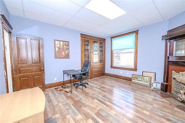 office area featuring wood-type flooring and a paneled ceiling