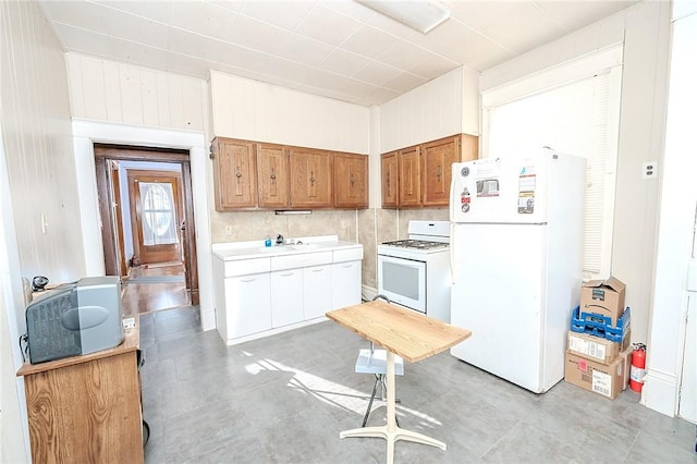 kitchen with white cabinetry, white appliances, and backsplash