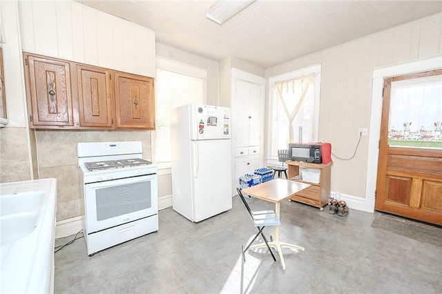 kitchen featuring white appliances and sink