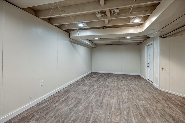 basement with light hardwood / wood-style floors