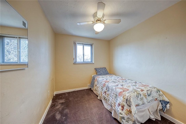 bedroom featuring dark colored carpet and ceiling fan