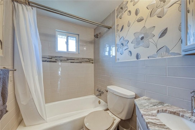 full bathroom with vanity, toilet, tile walls, and shower / tub combo