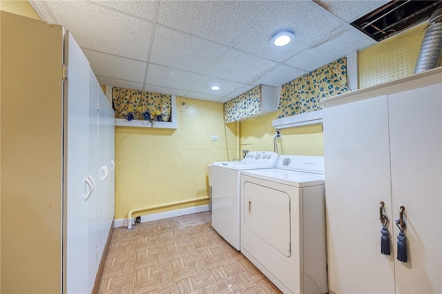 laundry room featuring washing machine and dryer and light parquet floors