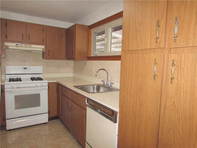 kitchen featuring decorative backsplash, white appliances, and sink