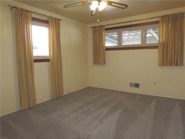 unfurnished room featuring ceiling fan and carpet floors