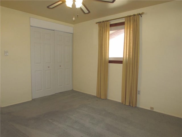 unfurnished bedroom with carpet flooring, ceiling fan, and a closet