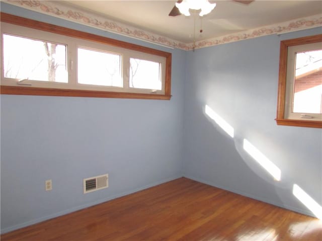 unfurnished room with wood-type flooring and ceiling fan