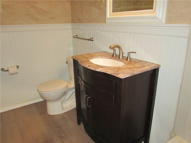 bathroom featuring hardwood / wood-style floors, vanity, and toilet