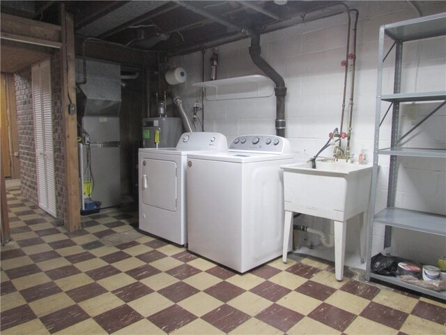 laundry room with washer and dryer and gas water heater