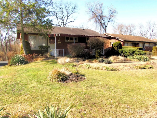 ranch-style home with a front yard and a porch