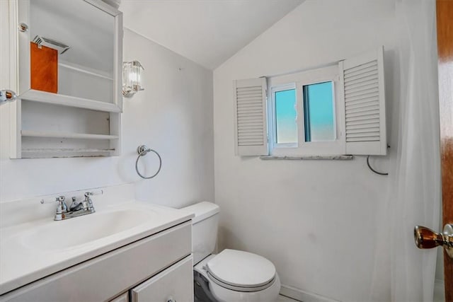 bathroom with vanity, toilet, and vaulted ceiling