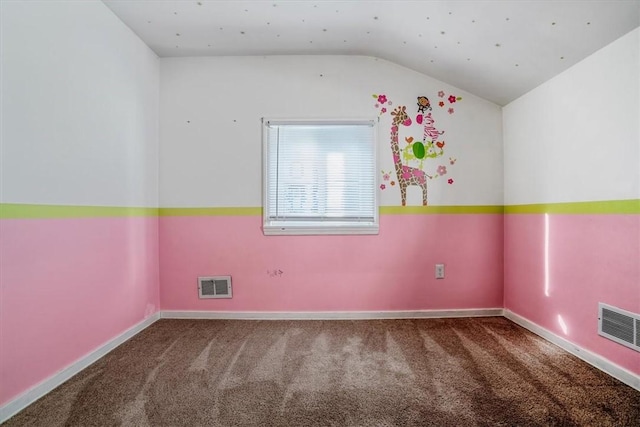 empty room featuring carpet and lofted ceiling