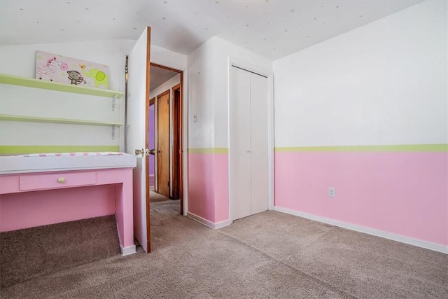 interior space with light colored carpet and lofted ceiling