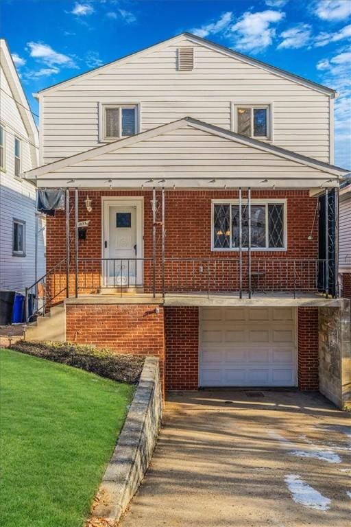 view of front of home with a front yard and a garage