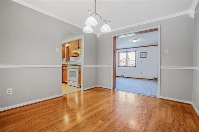 unfurnished dining area featuring crown molding, a notable chandelier, and light wood-type flooring