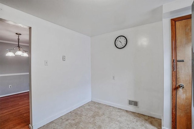 spare room featuring light hardwood / wood-style floors and ornamental molding