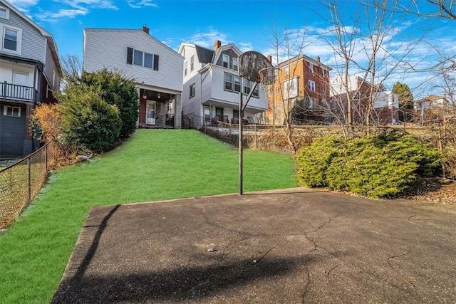 view of basketball court featuring a lawn