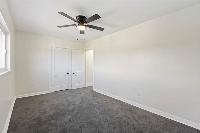 carpeted spare room with ceiling fan