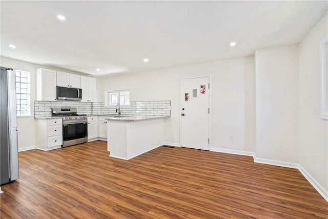 kitchen featuring plenty of natural light, white cabinets, and stainless steel appliances