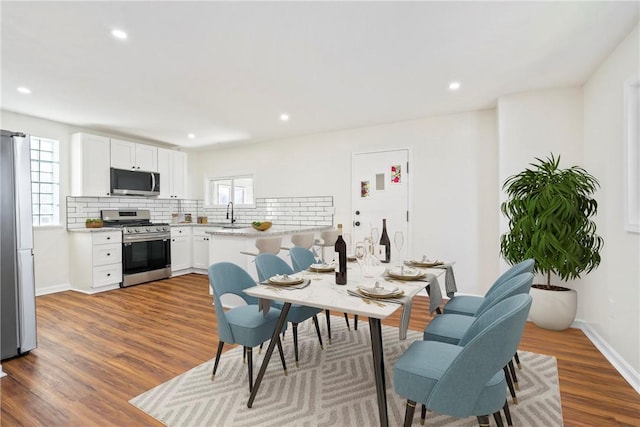 dining space featuring a wealth of natural light, dark hardwood / wood-style flooring, and sink