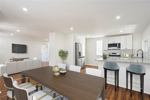 dining area with dark wood-type flooring and sink