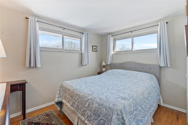 bedroom featuring multiple windows and hardwood / wood-style floors