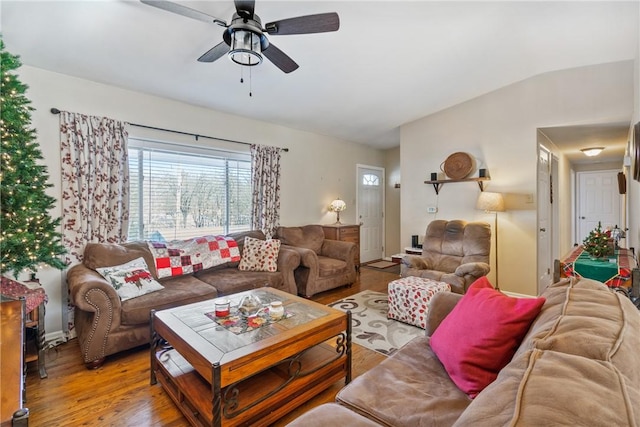 living room featuring ceiling fan, vaulted ceiling, and hardwood / wood-style flooring