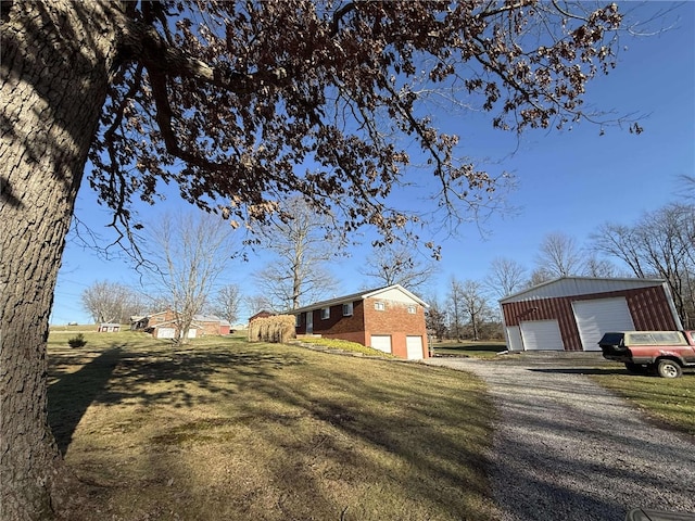 view of side of home featuring a garage and a yard