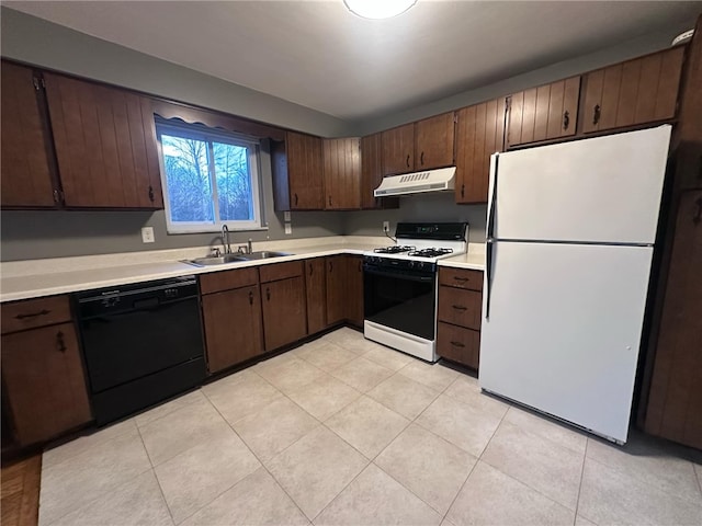 kitchen with dark brown cabinets, white appliances, light tile patterned floors, and sink