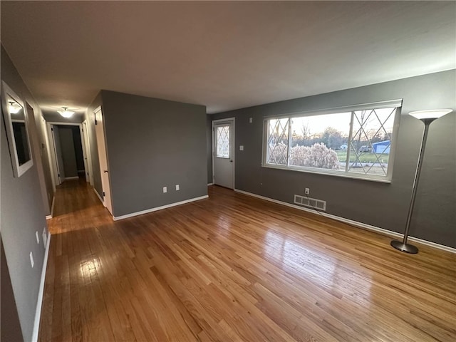 unfurnished living room with hardwood / wood-style floors