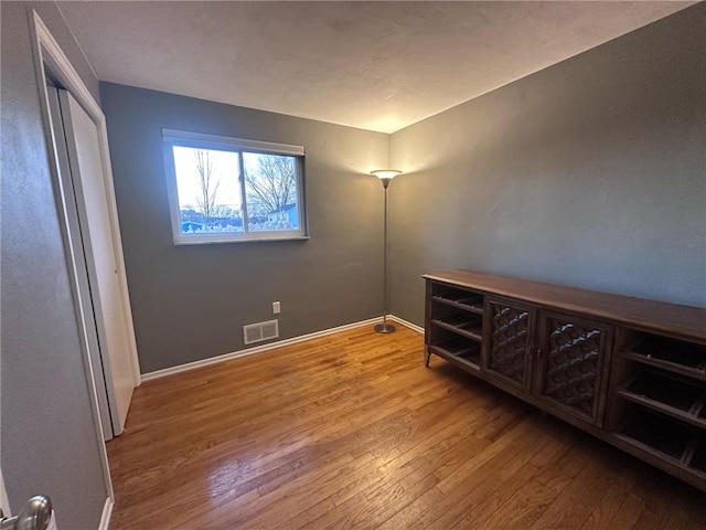 unfurnished room featuring hardwood / wood-style flooring