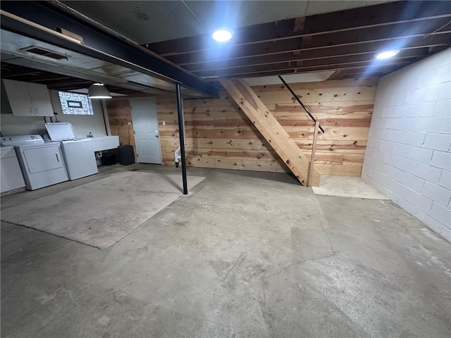 basement with washer and clothes dryer and sink