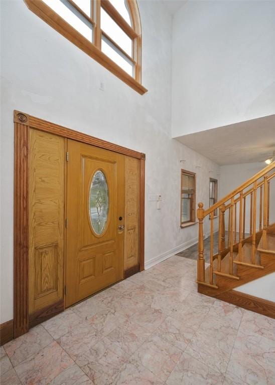 entryway with a wealth of natural light and a high ceiling