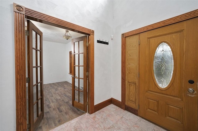 entryway with french doors and light hardwood / wood-style flooring