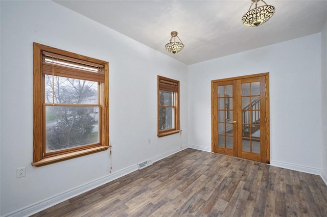 empty room featuring hardwood / wood-style floors and french doors