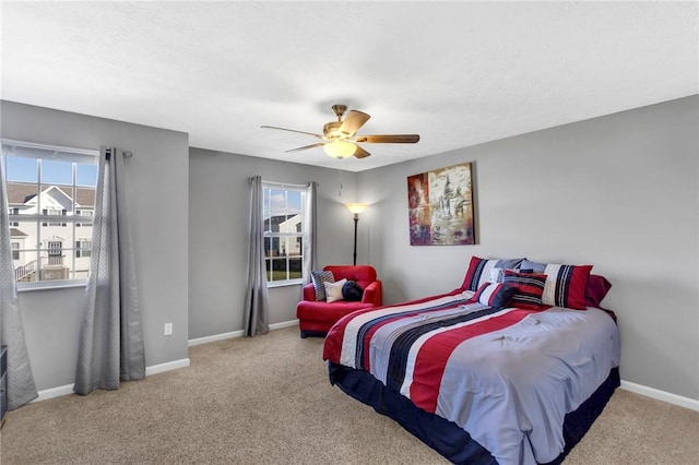 carpeted bedroom featuring ceiling fan and multiple windows