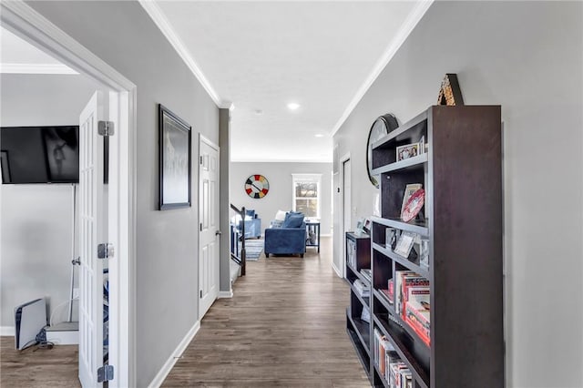 corridor with dark hardwood / wood-style floors and ornamental molding