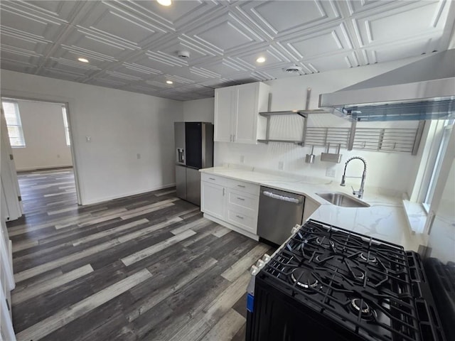 kitchen with stainless steel dishwasher, black range with gas stovetop, white cabinetry, and sink