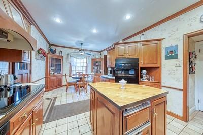 kitchen featuring ornamental molding, light tile patterned floors, and wooden counters