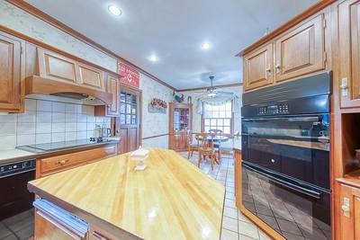 kitchen with wooden counters, ceiling fan, crown molding, and black appliances