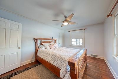 bedroom with ceiling fan and dark wood-type flooring