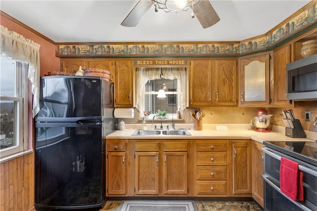 kitchen with appliances with stainless steel finishes, tasteful backsplash, crown molding, and sink