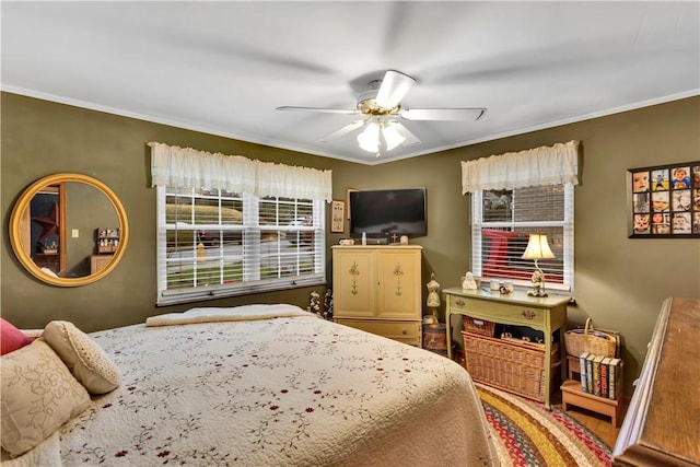 bedroom with ceiling fan, crown molding, and multiple windows