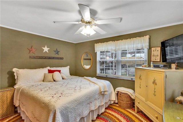 bedroom with wood-type flooring, ceiling fan, and crown molding