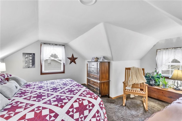 carpeted bedroom featuring multiple windows and vaulted ceiling