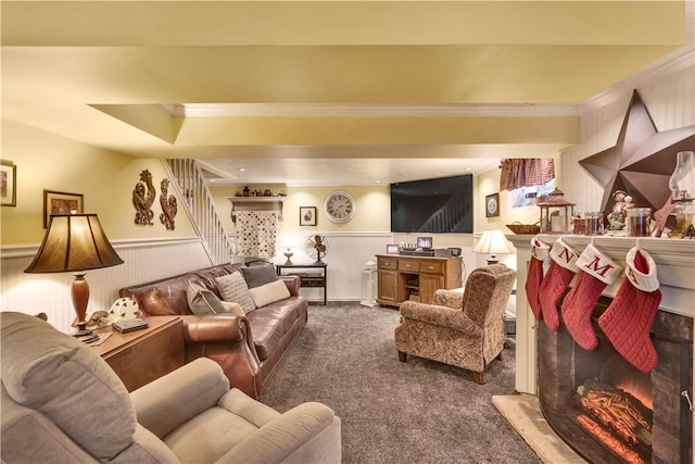 carpeted living room with crown molding and a tray ceiling