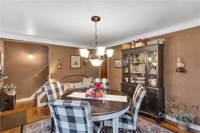 dining room with a notable chandelier and dark hardwood / wood-style floors