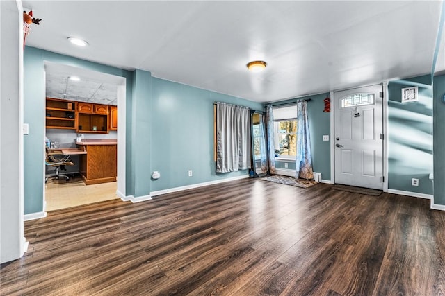 interior space with dark hardwood / wood-style floors and built in desk