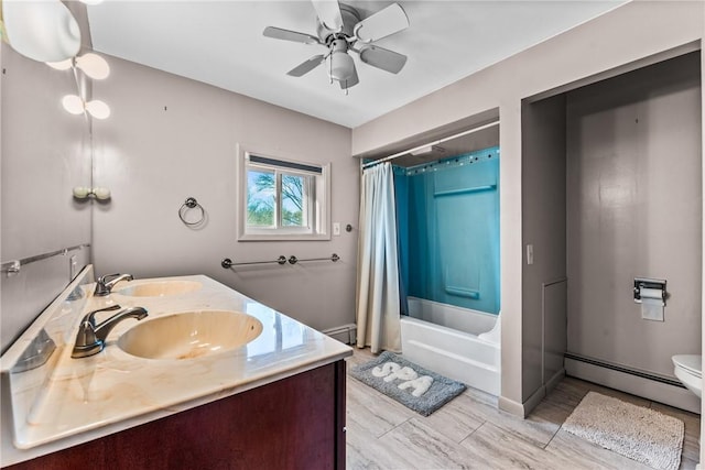 full bathroom featuring vanity, ceiling fan, shower / bath combo with shower curtain, a baseboard radiator, and toilet