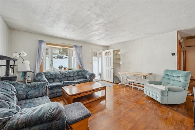 living room featuring hardwood / wood-style floors and a textured ceiling